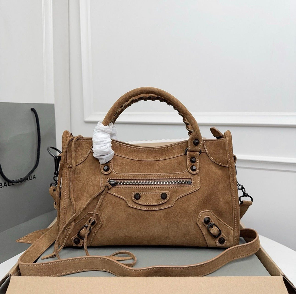 Chocolate brown Balenciaga leather city shoulder bag on display