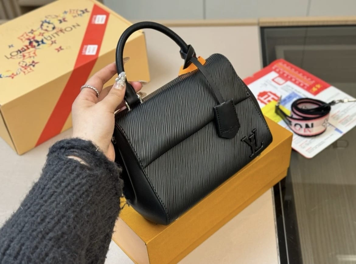 Black structured women’s handbag with shoulder strap
