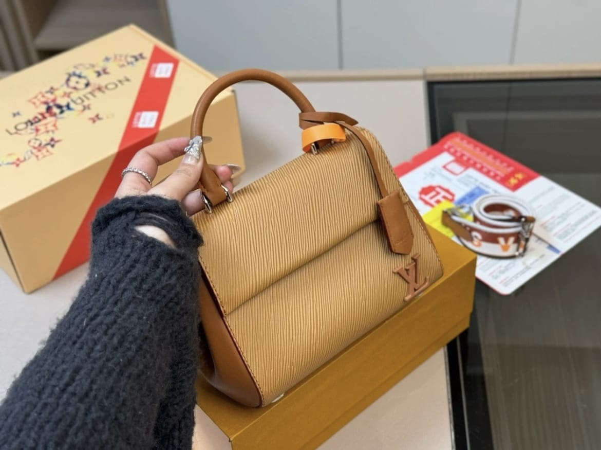 Brown structured women’s handbag with top handle