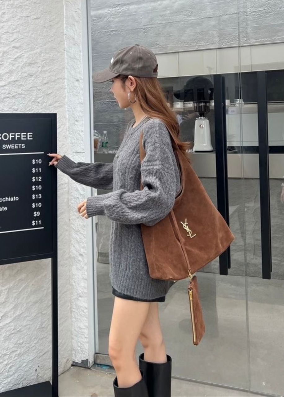 Woman carrying a brown YSL hobo shoulder bag
