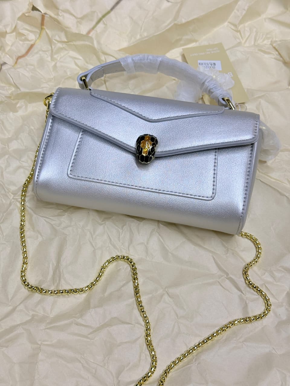 Angled view of silver BVLGARI women’s mini bag