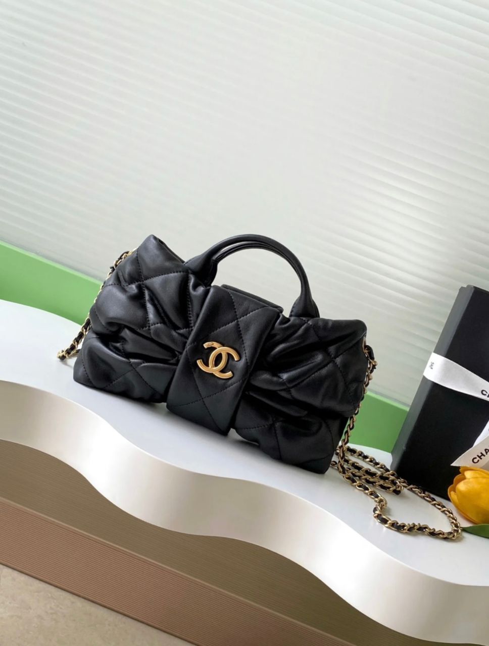 Front view of black Chanel quilted handbag