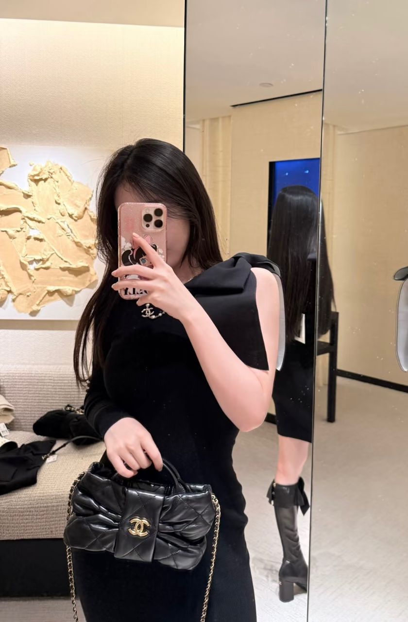 Woman carrying a black Chanel quilted bag available in UAE