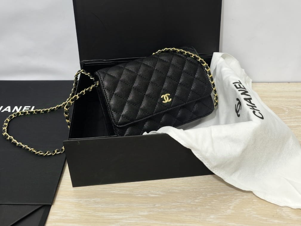 Angled view of black Chanel wallet-on-chain bag