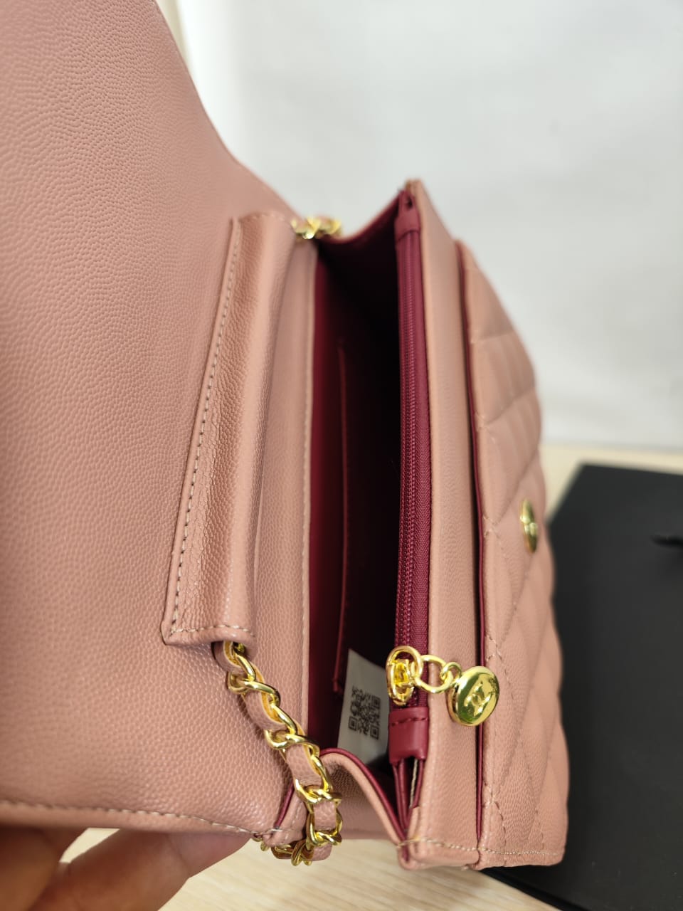 Side view of pink Chanel wallet-on-chain bag