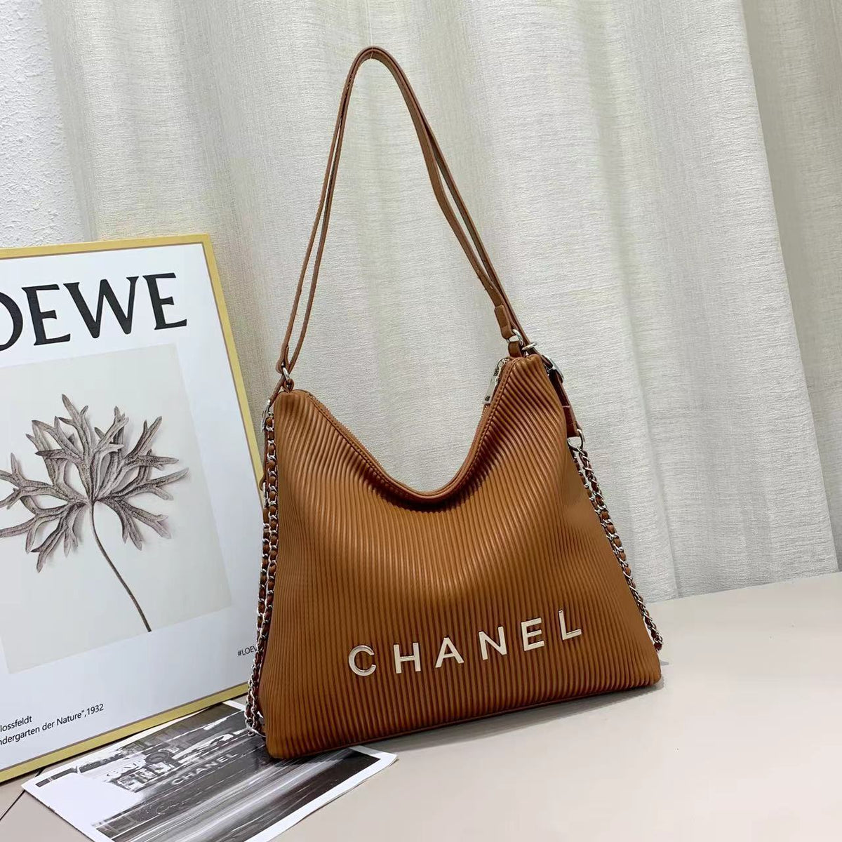 Brown Chanel women's handbag with curved silhouette