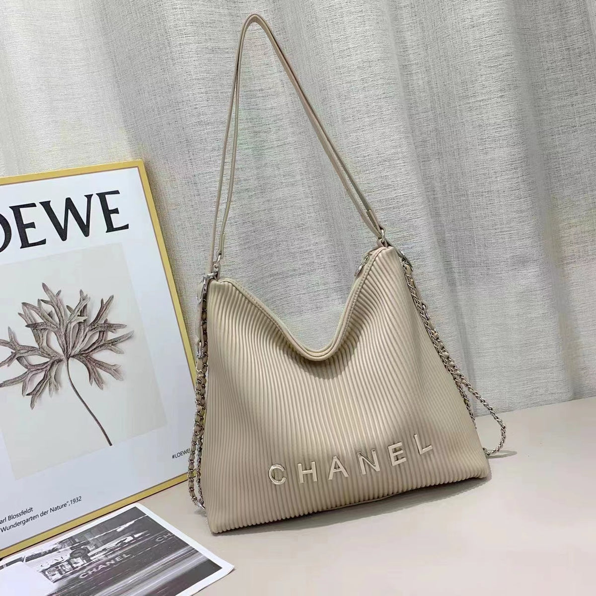 Beige Chanel women's bag with elegant shoulder strap
