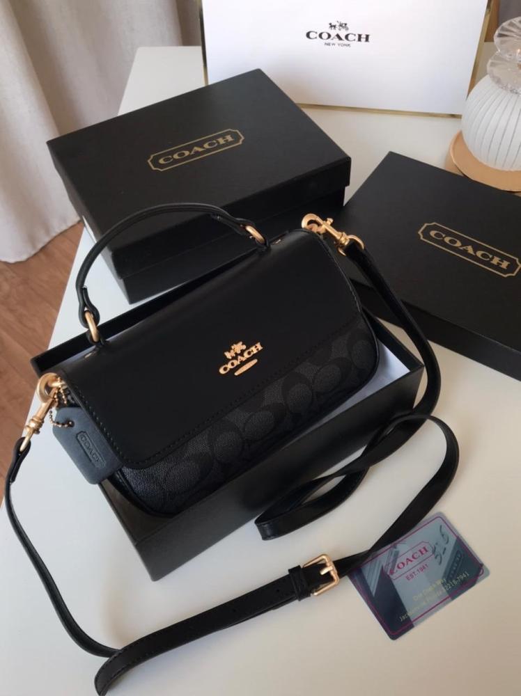 Front view of black Coach women’s crossbody bag