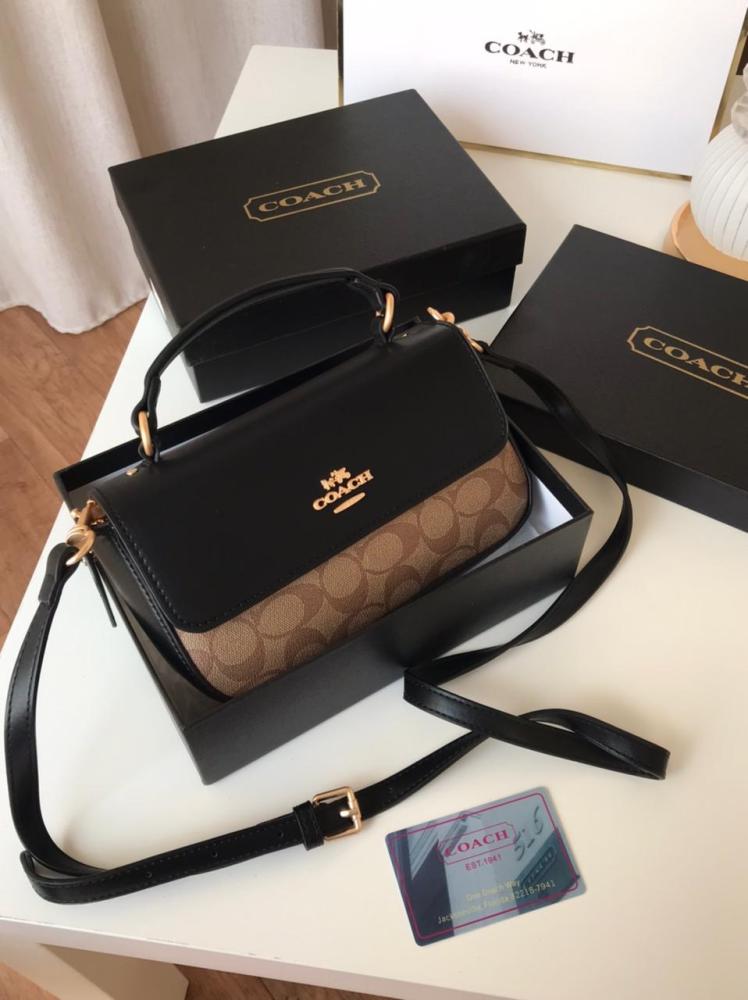 Front view of brown Coach structured crossbody bag