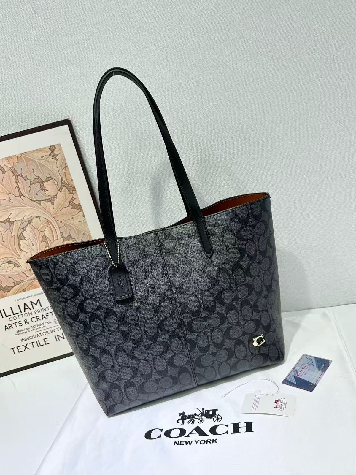Dark charcoal black Coach signature canvas tote bag with black handles