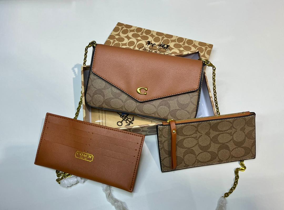 Brown Coach crossbody bag with coordinating accessories