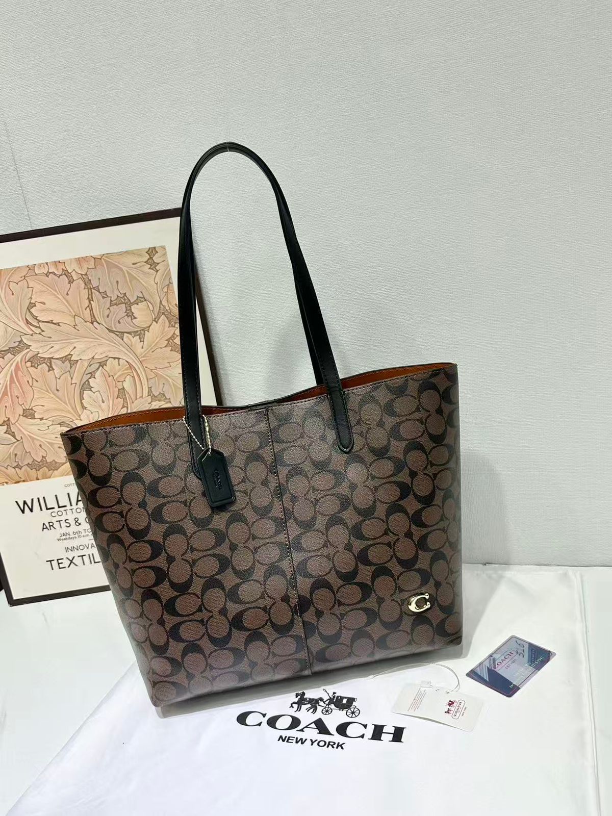 Dark brown Coach signature monogram tote bag with leather shoulder straps