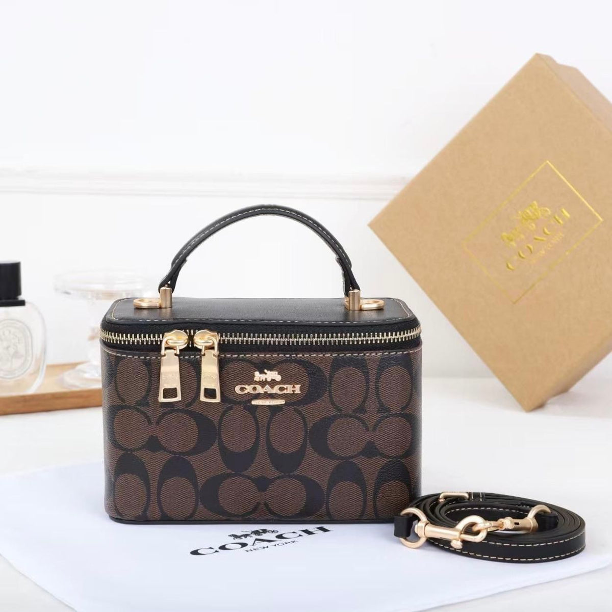 Coach mini vanity case bag in dark brown signature canvas with tan leather handle