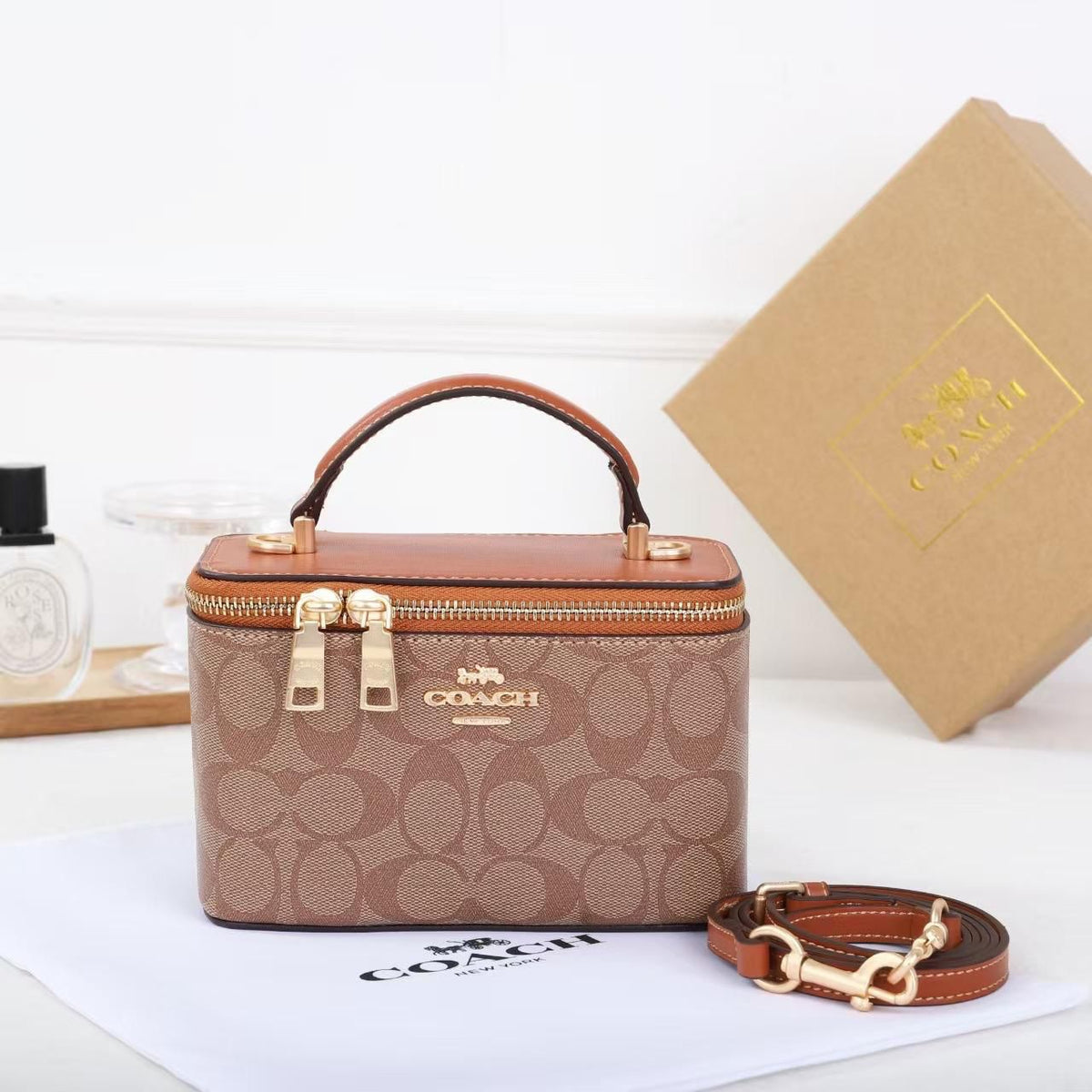 Tan brown Coach signature mini vanity top handle bag with crossbody strap