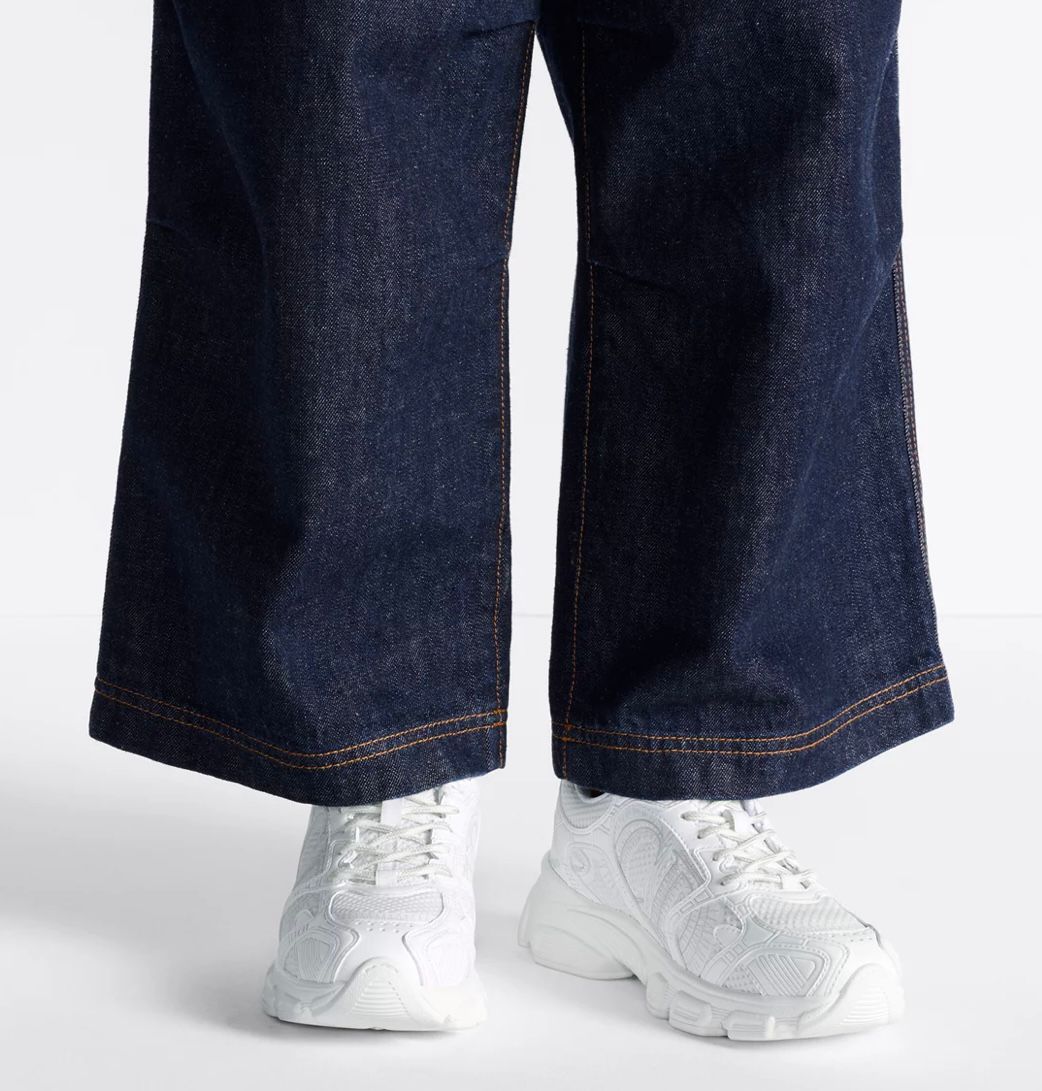 White Dior Chrono sneakers styled with wide-leg trousers