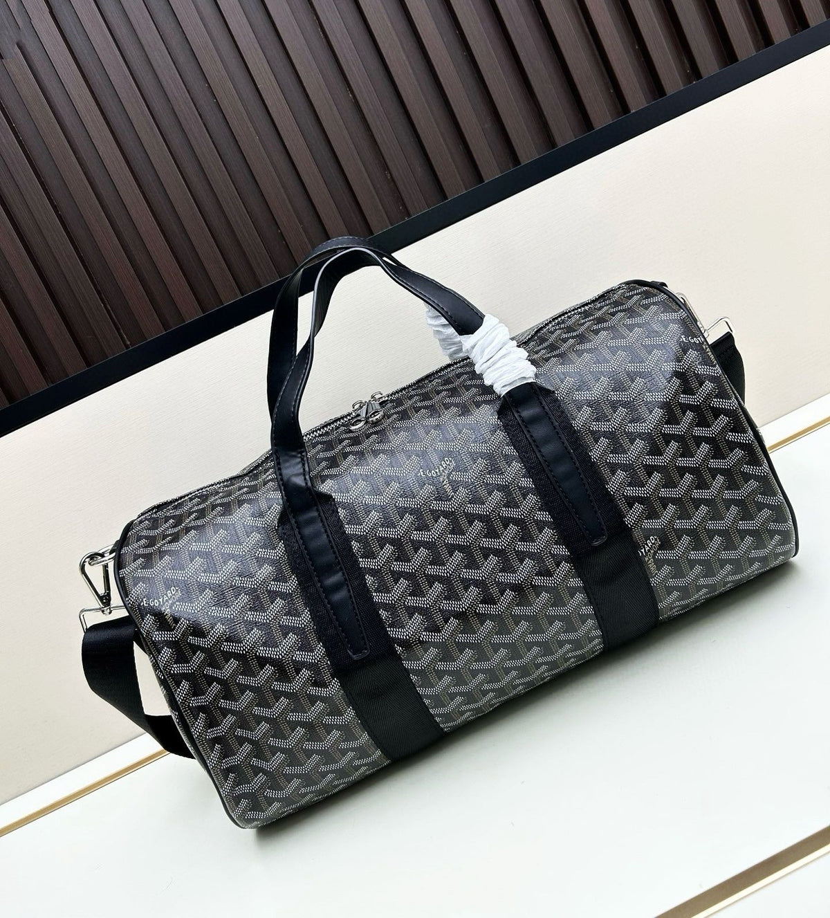Black Goyard Goyardine canvas cylinder duffel bag with matching black leather trim
