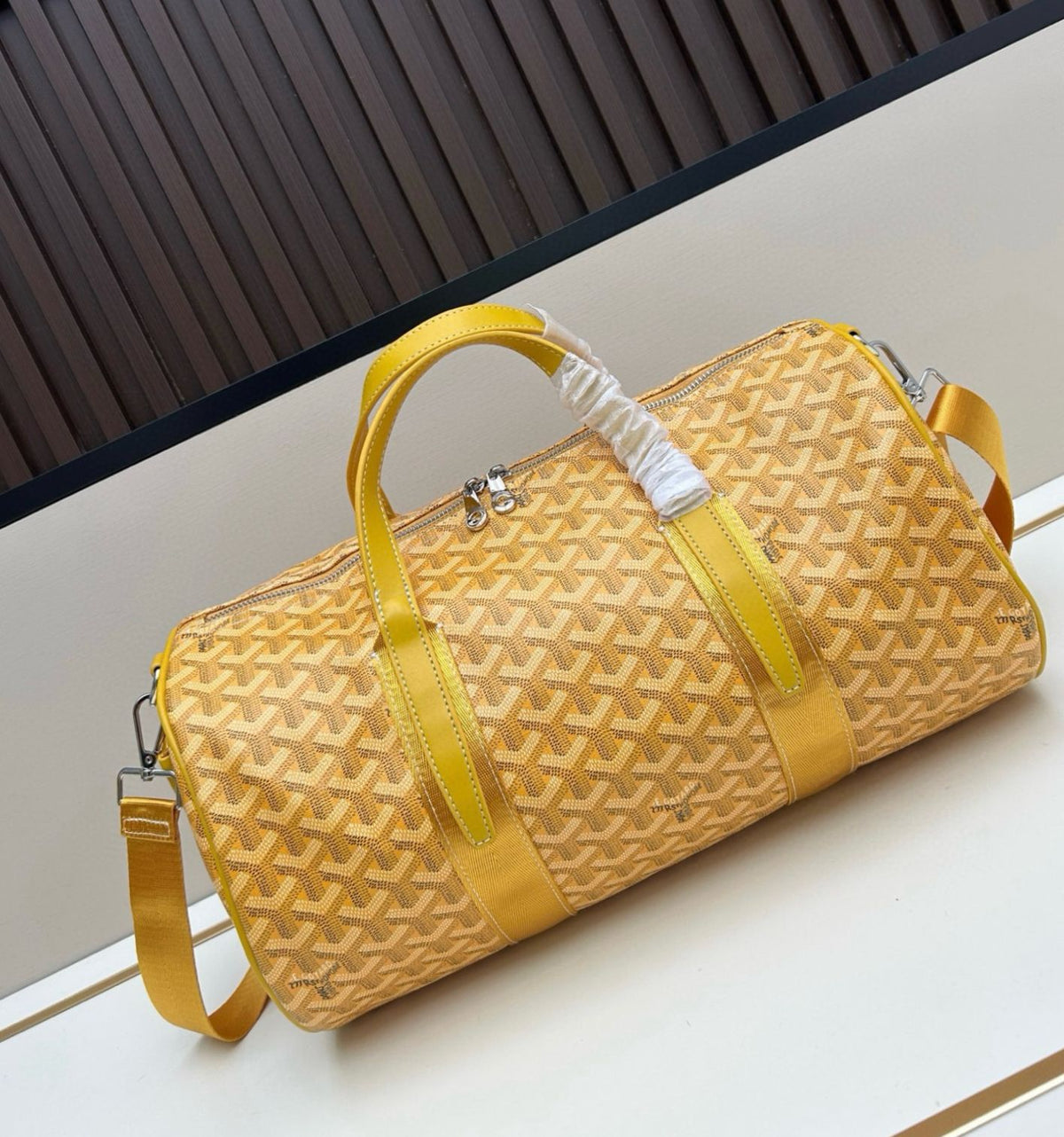Bright yellow Goyard Goyardine canvas cylinder top handle bag