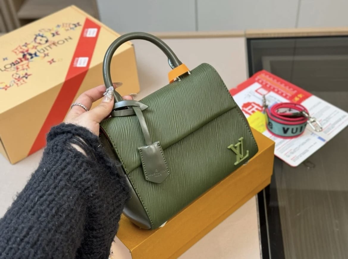 Green structured women’s handbag with top handle