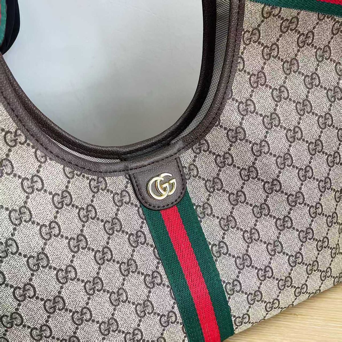 Close-up of Gucci tote bag monogram and striped detail