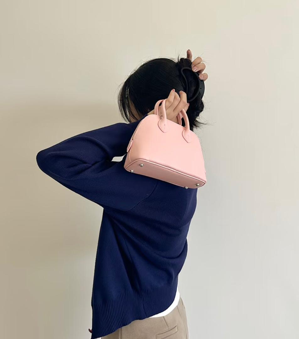 Back view of pink Hermès mini shoulder bag