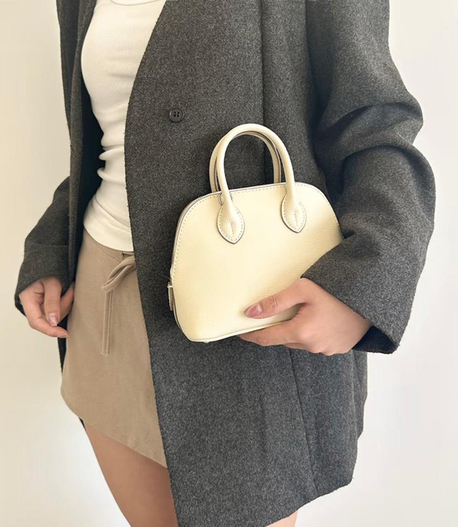 White Hermès mini handbag with curved handles
