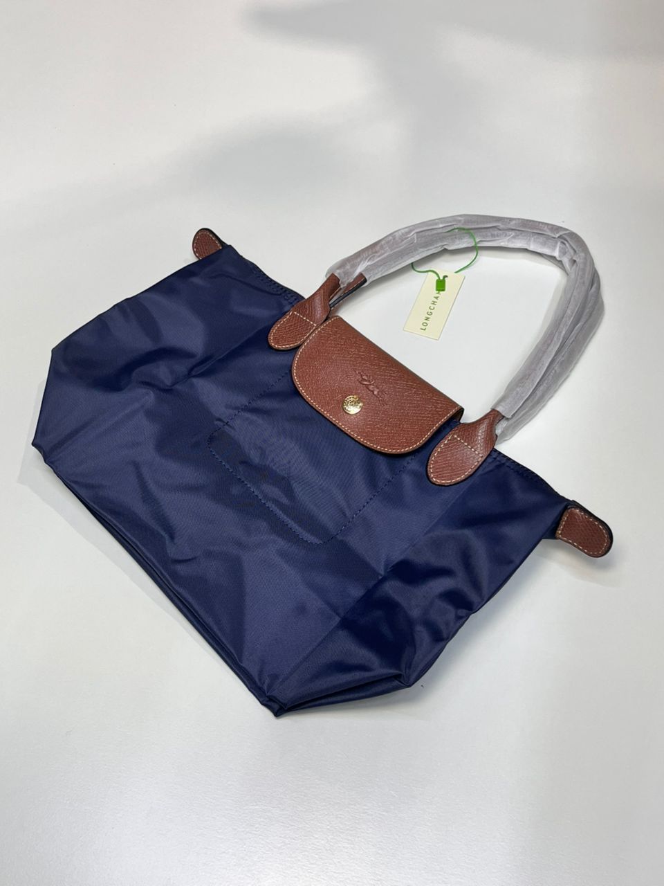 Blue Longchamp foldable tote bag with brown detail