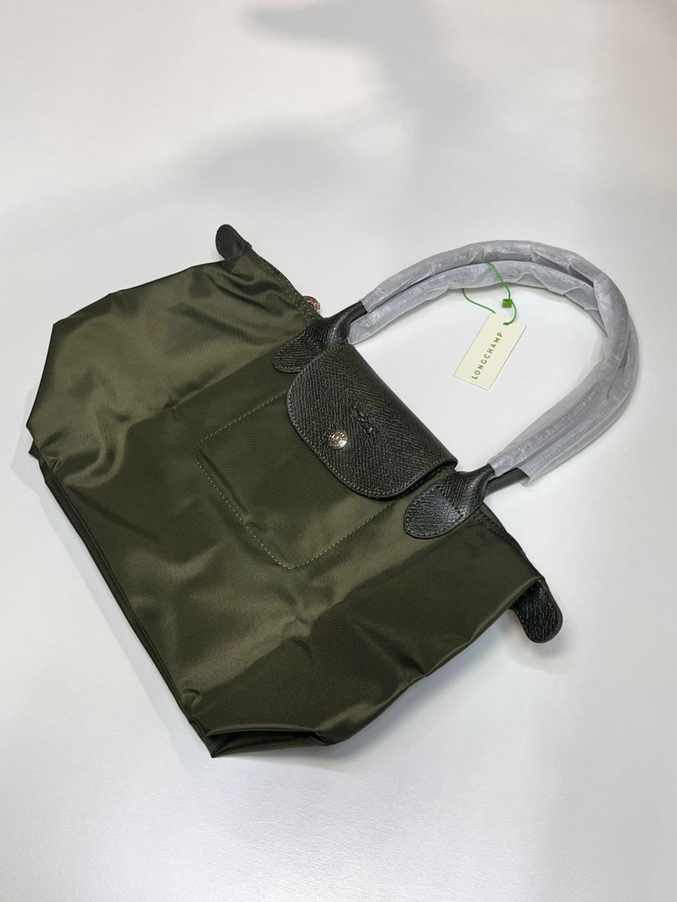 Green Longchamp women’s tote bag in folded form
