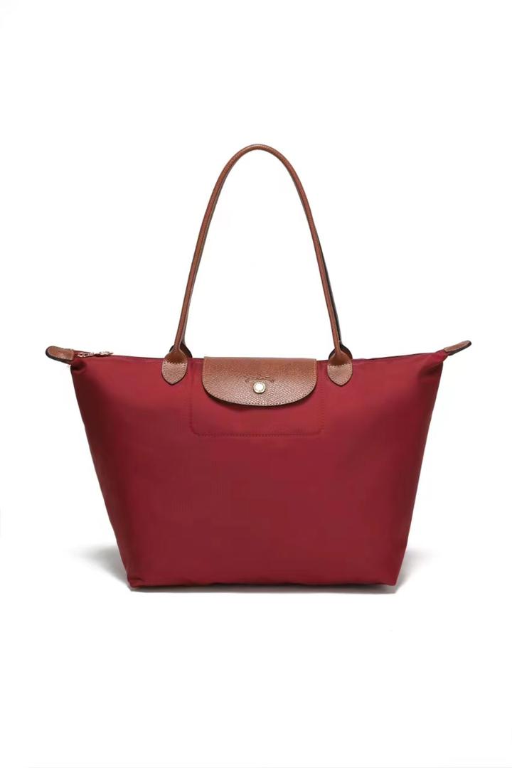 Red Longchamp women’s tote bag with shoulder handles