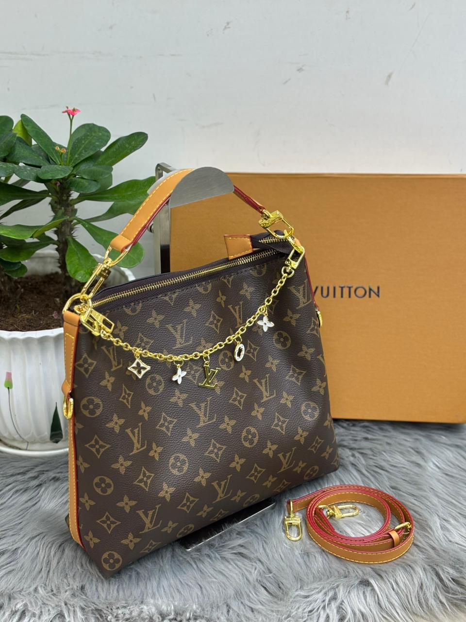 Louis Vuitton monogram canvas hobo shoulder bag with tan handle and charm chain