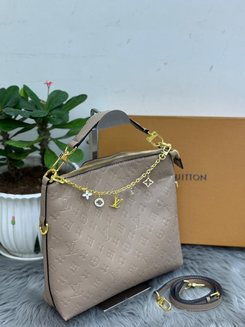 Taupe beige Louis Vuitton monogram empreinte leather hobo bag with gold charm