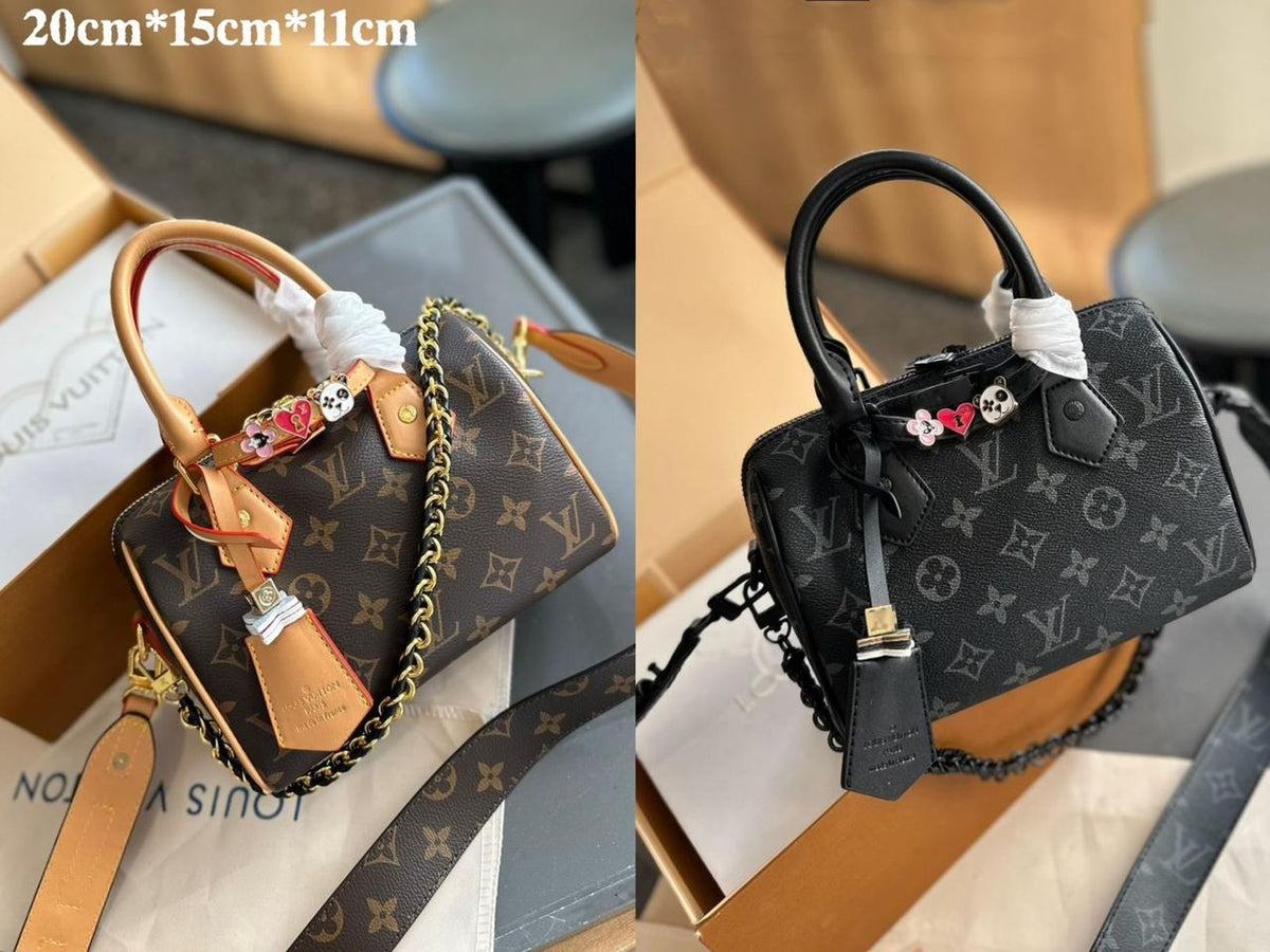 Louis Vuitton monogram mini top handle bag with charms measuring 20cm by 15cm by 11cm
