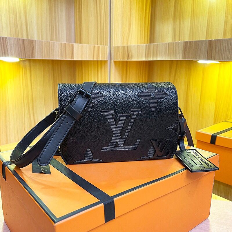Black monogram shoulder bag with embossed logo and adjustable strap