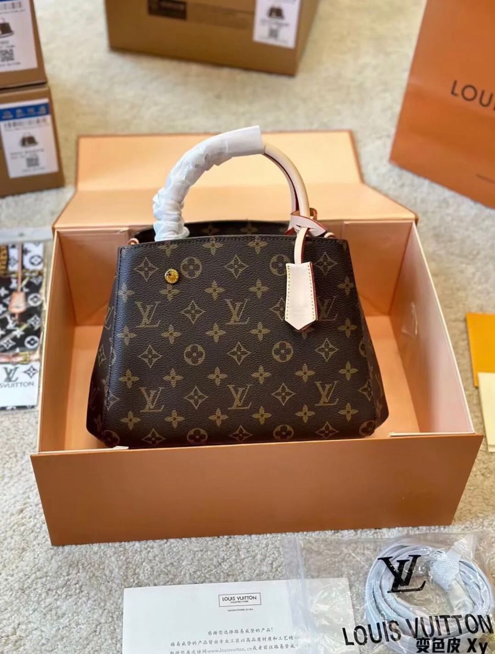 Louis Vuitton style monogram handbag angled view with structured shape