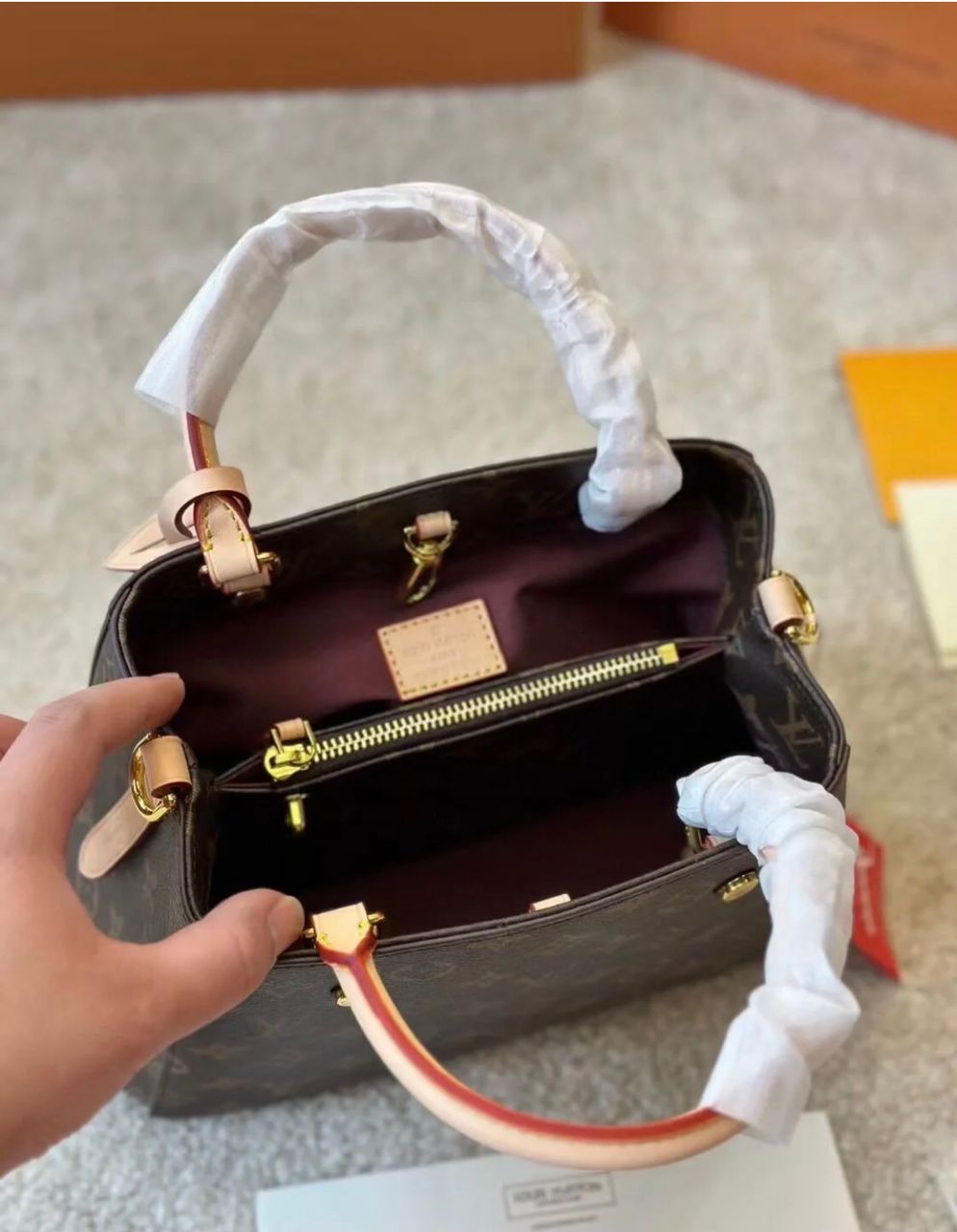 Louis Vuitton style women's handbag interior with zipper compartment