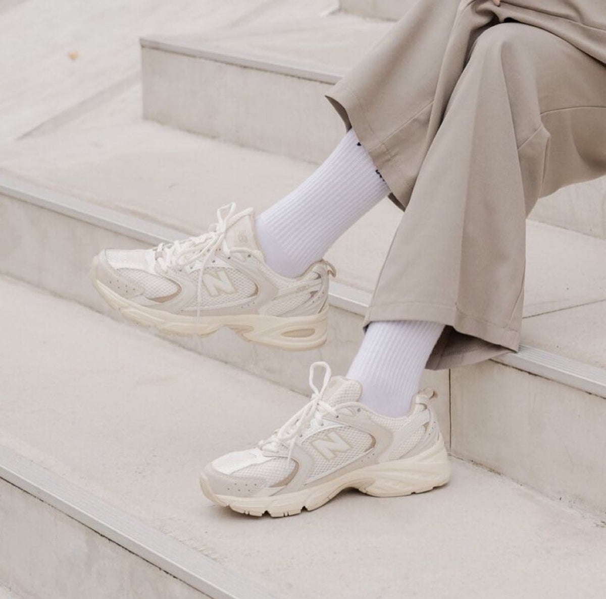 Cream New Balance 9060 sneakers styled with a neutral outfit