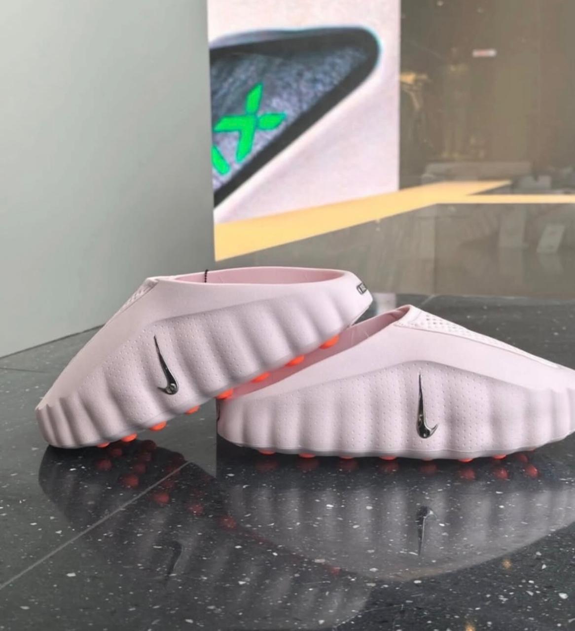 Nike Mind 001 Pearl Pink Hyper Crimson mules at Meya Luxury Brand