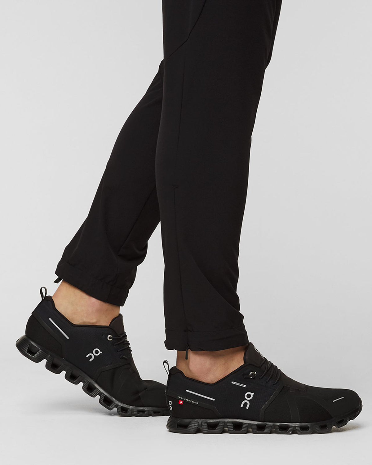 On Cloudventure Waterproof black trail shoes worn on feet