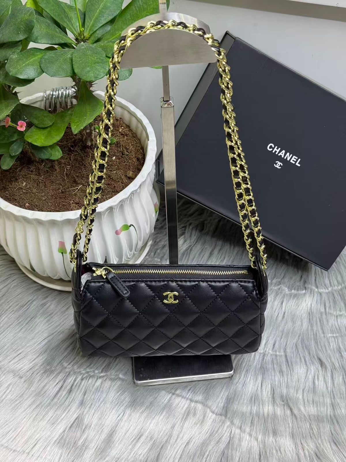 Black quilted leather mini chain crossbody bag with gold logo emblem and strap