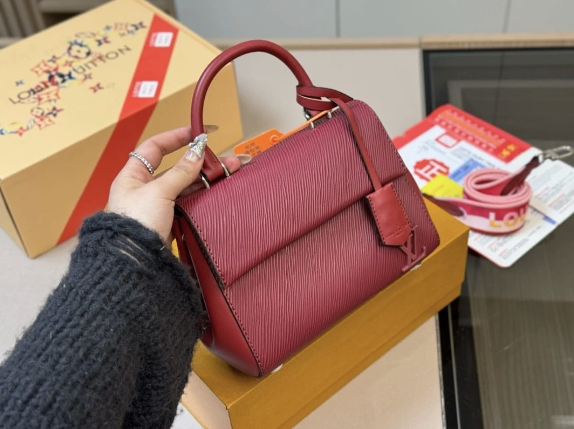 Red structured women’s handbag with top handle