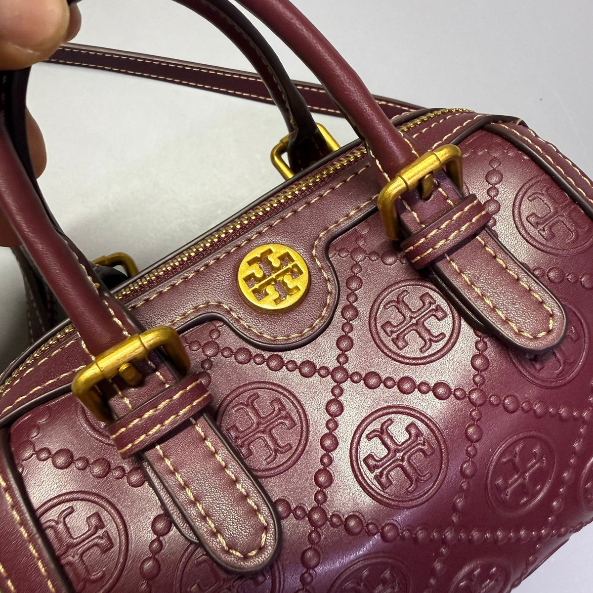 Embossed texture detail on Tory Burch style women's handbag